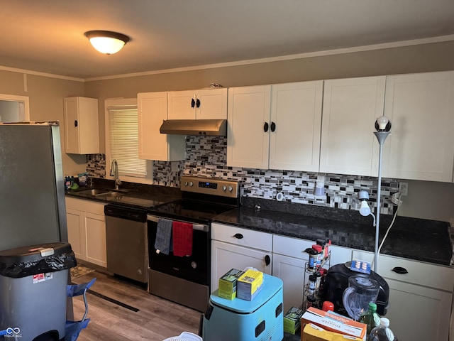 4006 Kenneth Ave, Indianapolis, IN 46226 - kitchen featuring stainless steel appliances, under cabinet range hood, wood finished floors, white cabinetry, and decorative backsplash