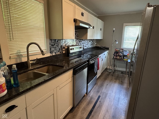 4006 Kenneth Ave, Indianapolis, IN 46226 - kitchen with stainless steel appliances, under cabinet range hood, white cabinets, crown molding, and dark wood-style floors