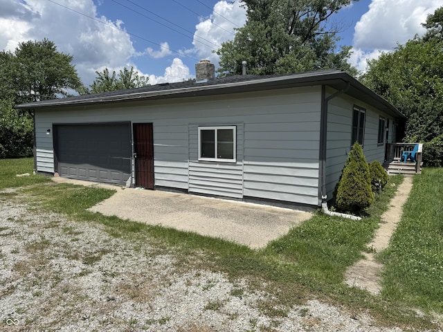 4006 Kenneth Ave, Indianapolis, IN 46226 - rear view of house featuring a chimney and a detached garage