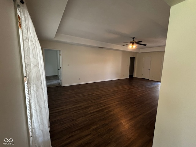 321 S Locust Dr, Morristown, IN 46161 - empty room with dark wood-style flooring, a ceiling fan, and a raised ceiling