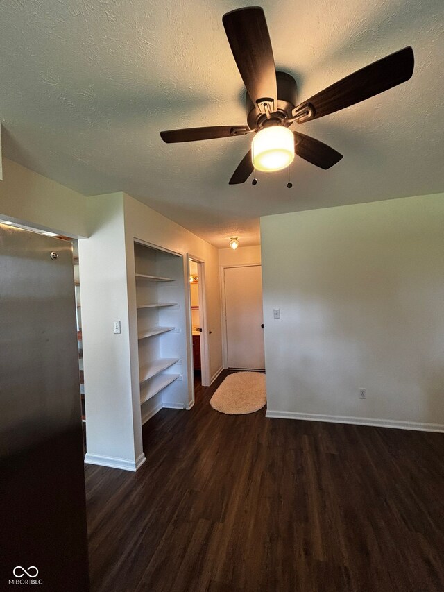 321 S Locust Dr, Morristown, IN 46161 - unfurnished room featuring wood finished floors, a ceiling fan, built in shelves, and a textured ceiling