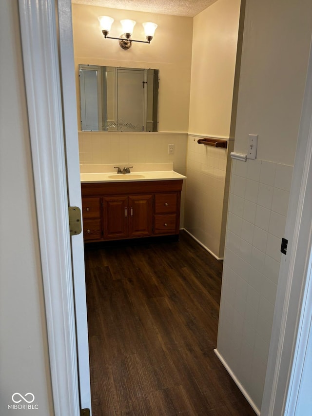 321 S Locust Dr, Morristown, IN 46161 - bathroom featuring tile walls, wood finished floors, vanity, and wainscoting