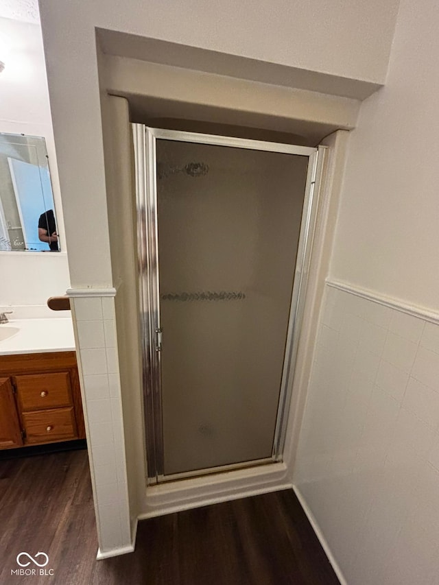 321 S Locust Dr, Morristown, IN 46161 - full bathroom featuring wood finished floors, vanity, and a stall shower