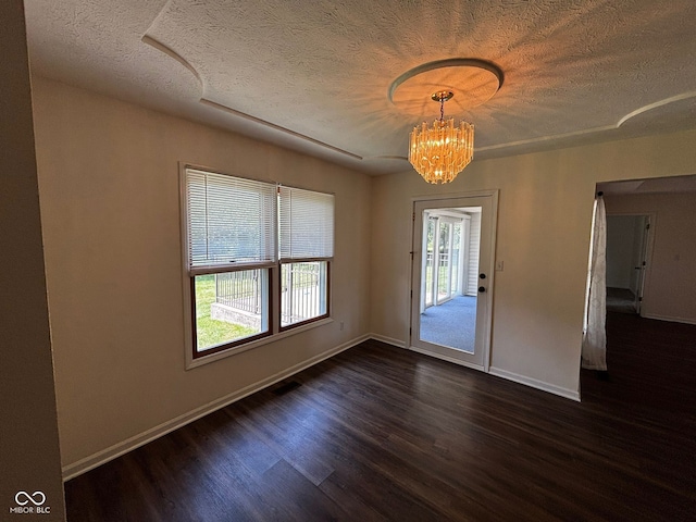 321 S Locust Dr, Morristown, IN 46161 - unfurnished dining area featuring a textured ceiling, dark wood finished floors, and a chandelier