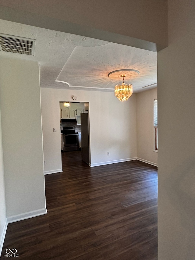 321 S Locust Dr, Morristown, IN 46161 - unfurnished dining area with a chandelier, dark wood-type flooring, and a textured ceiling