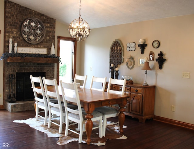 6022 S 550th Rd E, Franklin, IN 46131 - dining room with dark wood finished floors, a chandelier, a fireplace, and vaulted ceiling