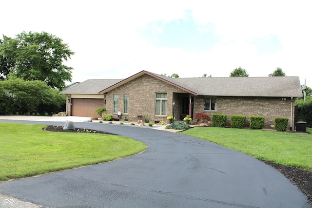 6022 S 550th Rd E, Franklin, IN 46131 - single story home featuring concrete driveway, an attached garage, brick siding, and a front yard
