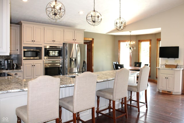6022 S 550th Rd E, Franklin, IN 46131 - kitchen with a chandelier, appliances with stainless steel finishes, decorative light fixtures, light stone counters, and lofted ceiling