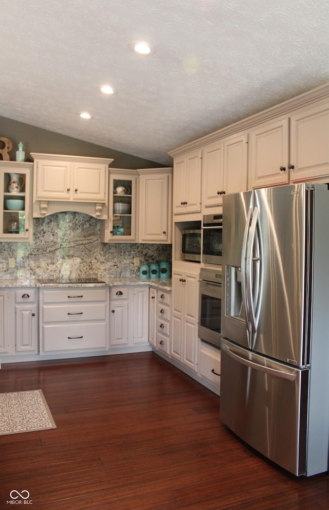 6022 S 550th Rd E, Franklin, IN 46131 - kitchen featuring appliances with stainless steel finishes, vaulted ceiling, decorative backsplash, glass insert cabinets, and recessed lighting