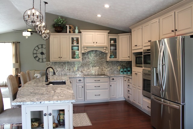 6022 S 550th Rd E, Franklin, IN 46131 - kitchen with lofted ceiling, a peninsula, appliances with stainless steel finishes, a textured ceiling, and backsplash