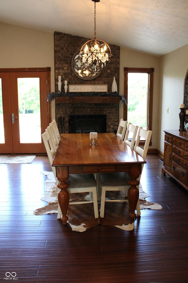6022 S 550th Rd E, Franklin, IN 46131 - dining area featuring lofted ceiling, a fireplace, healthy amount of natural light, a chandelier, and dark wood-style floors