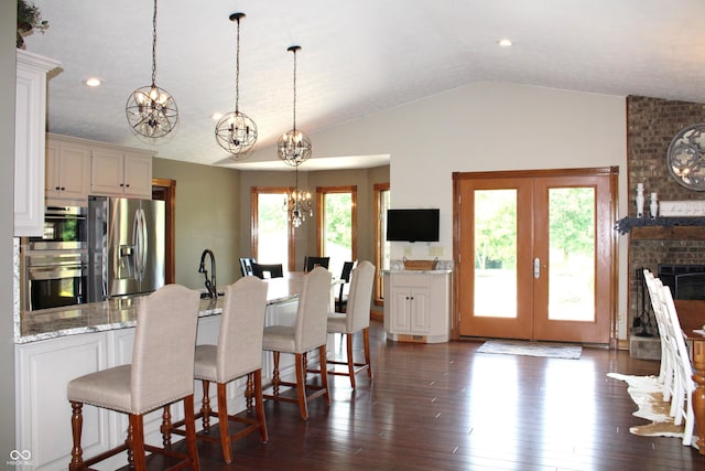 6022 S 550th Rd E, Franklin, IN 46131 - kitchen with a chandelier, a peninsula, stainless steel appliances, a breakfast bar, and hanging light fixtures