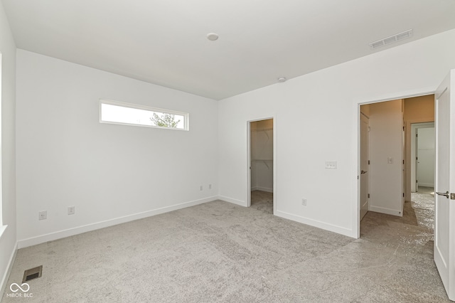 2416 Winthrop Ave, Indianapolis, IN 46205 - unfurnished bedroom with carpet floors and a spacious closet