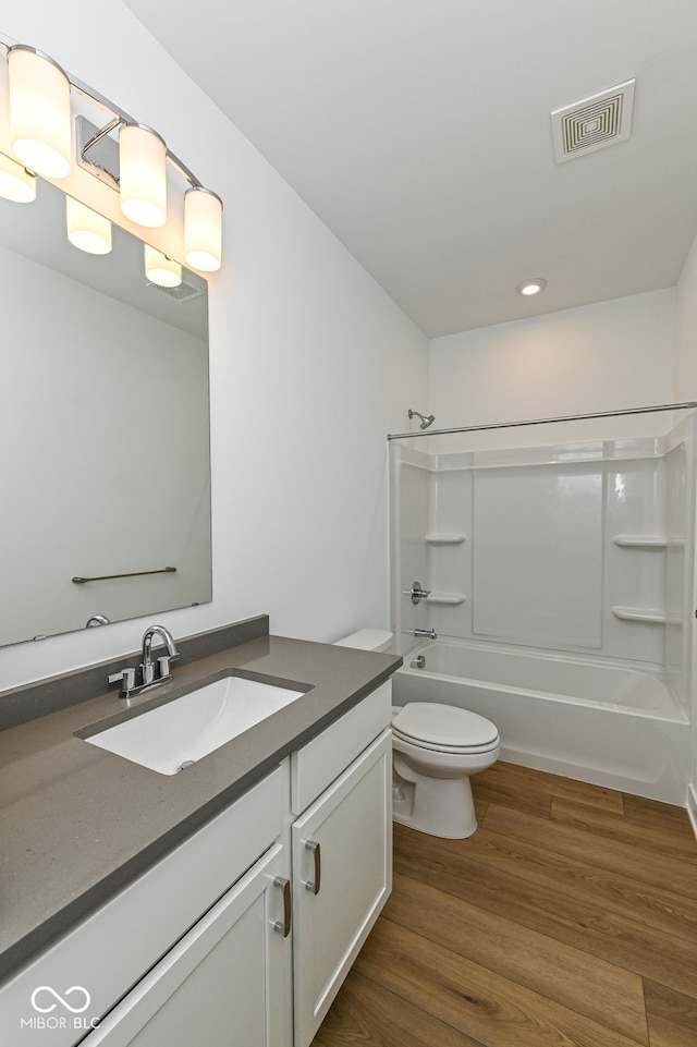 2416 Winthrop Ave, Indianapolis, IN 46205 - bathroom featuring vanity, bathing tub / shower combination, wood finished floors, and recessed lighting