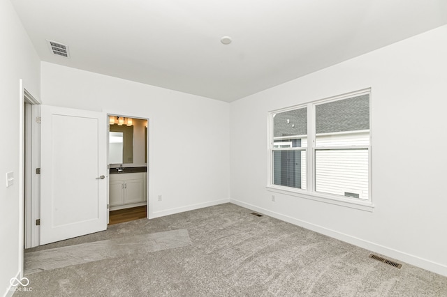 2416 Winthrop Ave, Indianapolis, IN 46205 - unfurnished bedroom with carpet, multiple windows, and connected bathroom