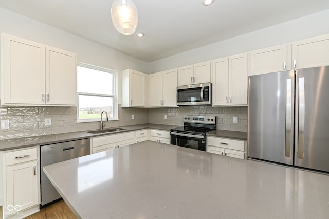 2416 Winthrop Ave, Indianapolis, IN 46205 - kitchen featuring appliances with stainless steel finishes, white cabinetry, backsplash, recessed lighting, and wood finished floors