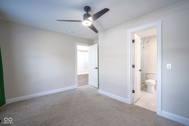 1409 Terrace Ave, Indianapolis, IN 46203 - unfurnished bedroom featuring carpet floors, ensuite bathroom, and a ceiling fan