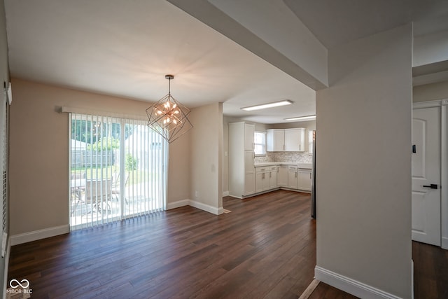1409 Terrace Ave, Indianapolis, IN 46203 - unfurnished dining area with dark wood-style flooring and a chandelier