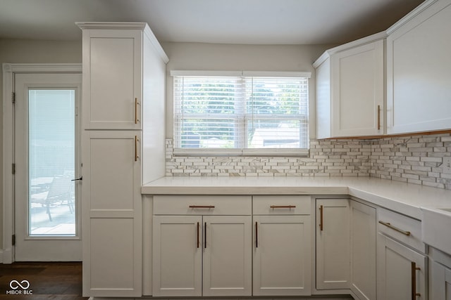 1409 Terrace Ave, Indianapolis, IN 46203 - kitchen with healthy amount of natural light, decorative backsplash, white cabinetry, and light countertops