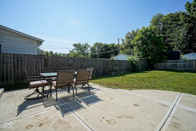 1409 Terrace Ave, Indianapolis, IN 46203 - fenced backyard with outdoor dining area and a patio