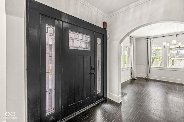 4123 N Illinois St, Indianapolis, IN 46208 - foyer entrance featuring arched walkways, dark wood finished floors, crown molding, and a chandelier