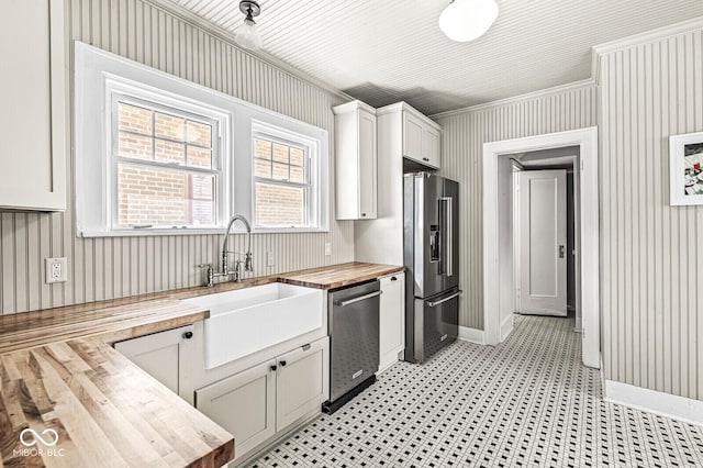 4123 N Illinois St, Indianapolis, IN 46208 - kitchen featuring wood counters, appliances with stainless steel finishes, ornamental molding, white cabinets, and light flooring