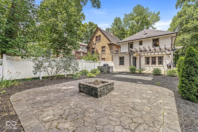 4123 N Illinois St, Indianapolis, IN 46208 - rear view of house with a pergola, a patio, a fire pit, and brick siding