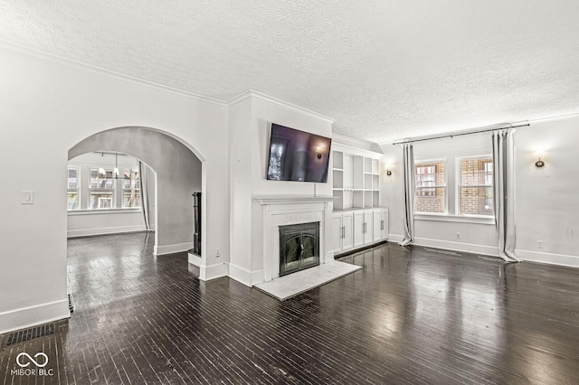 4123 N Illinois St, Indianapolis, IN 46208 - unfurnished living room with a glass covered fireplace, a textured ceiling, healthy amount of natural light, dark wood-style floors, and crown molding
