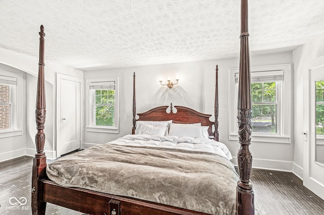 4123 N Illinois St, Indianapolis, IN 46208 - bedroom with wood finished floors, multiple windows, and a textured ceiling