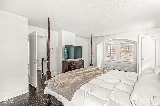 4123 N Illinois St, Indianapolis, IN 46208 - bedroom with dark wood-type flooring, a textured ceiling, and arched walkways