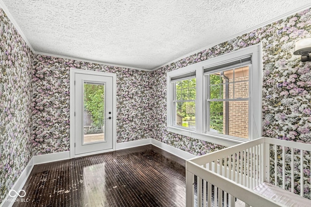 4123 N Illinois St, Indianapolis, IN 46208 - unfurnished room featuring wallpapered walls, a textured ceiling, crown molding, dark wood finished floors, and plenty of natural light