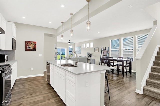 887 Tuxedo Dr, Westfield, IN 46074 - kitchen featuring appliances with stainless steel finishes, a kitchen breakfast bar, dark wood finished floors, ceiling fan, and recessed lighting