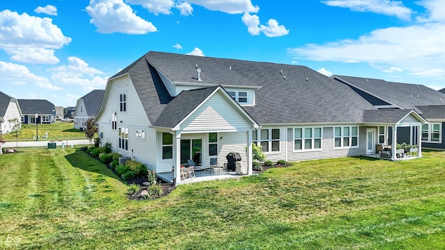887 Tuxedo Dr, Westfield, IN 46074 - rear view of house featuring a patio, a yard, a residential view, and a shingled roof