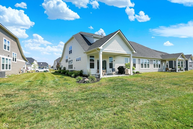 887 Tuxedo Dr, Westfield, IN 46074 - back of house featuring a patio, a yard, roof with shingles, and a residential view
