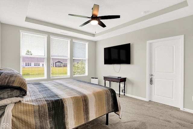 887 Tuxedo Dr, Westfield, IN 46074 - bedroom with a tray ceiling, light colored carpet, and a ceiling fan