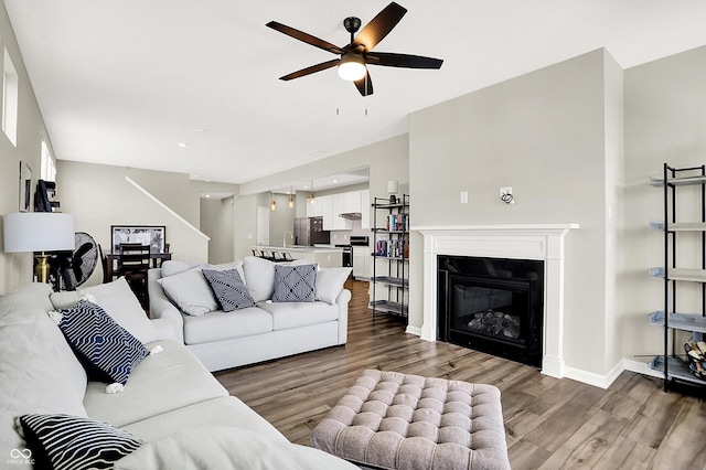 887 Tuxedo Dr, Westfield, IN 46074 - living room featuring ceiling fan, wood finished floors, stairway, and a glass covered fireplace