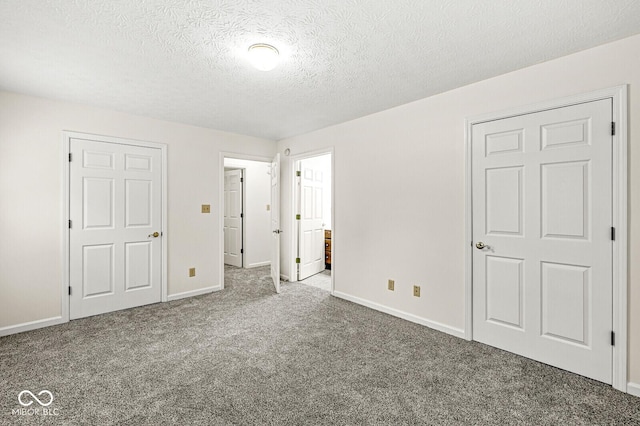 3772 Brill Rd, Indianapolis, IN 46227 - unfurnished bedroom featuring carpet flooring, a textured ceiling, and connected bathroom