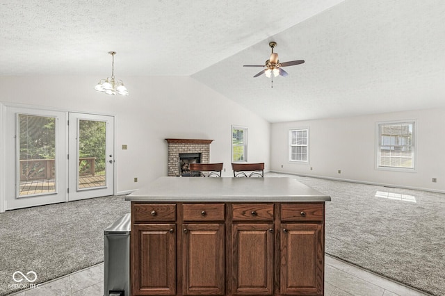 3772 Brill Rd, Indianapolis, IN 46227 - kitchen featuring light carpet, open floor plan, vaulted ceiling, a textured ceiling, and a fireplace