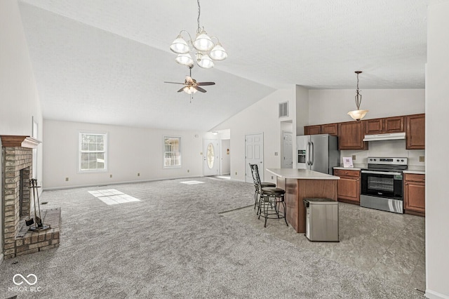 3772 Brill Rd, Indianapolis, IN 46227 - kitchen with appliances with stainless steel finishes, under cabinet range hood, light countertops, open floor plan, and hanging light fixtures