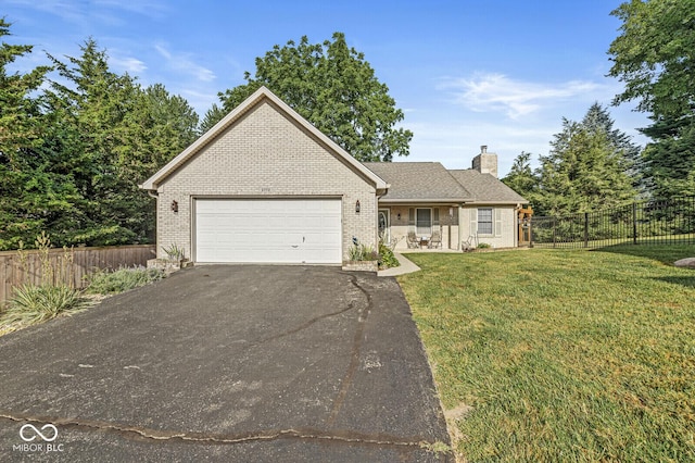 3772 Brill Rd, Indianapolis, IN 46227 - view of front of property with asphalt driveway, brick siding, an attached garage, and a chimney