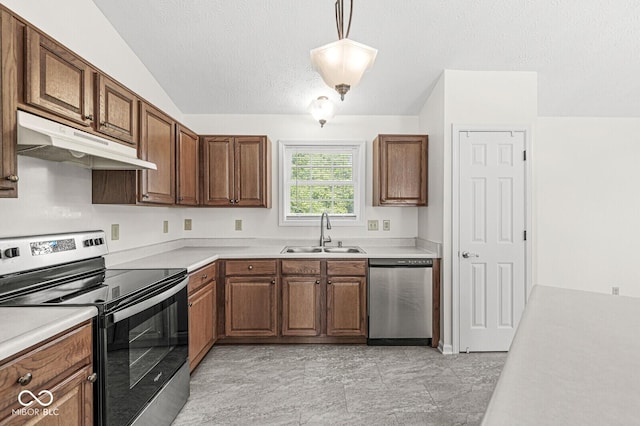 3772 Brill Rd, Indianapolis, IN 46227 - kitchen with stainless steel appliances, under cabinet range hood, light countertops, a textured ceiling, and brown cabinets