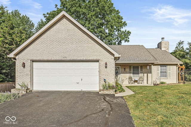 3772 Brill Rd, Indianapolis, IN 46227 - view of front facade featuring brick siding, driveway, a chimney, and an attached garage