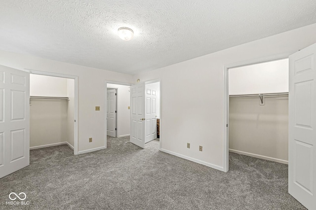 3772 Brill Rd, Indianapolis, IN 46227 - unfurnished bedroom featuring a spacious closet, carpet flooring, and a textured ceiling