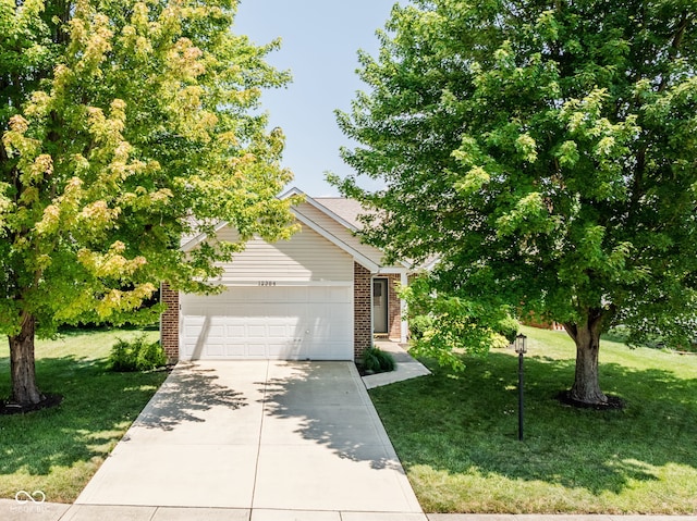 12384 Barnstone Ct, Fishers, IN 46037 - view of property hidden behind natural elements featuring an attached garage, a front yard, brick siding, and driveway