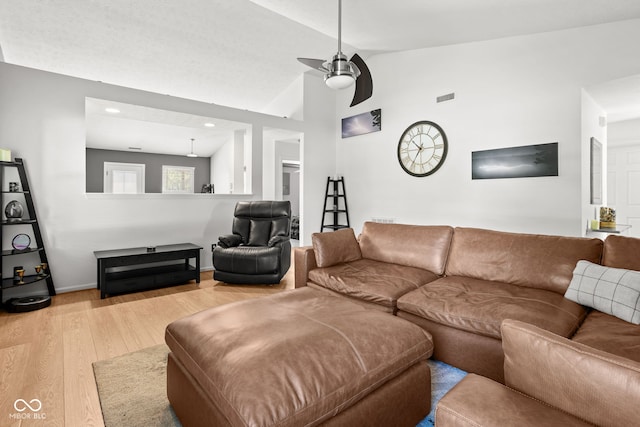 12384 Barnstone Ct, Fishers, IN 46037 - living area with light wood finished floors, lofted ceiling, and a ceiling fan