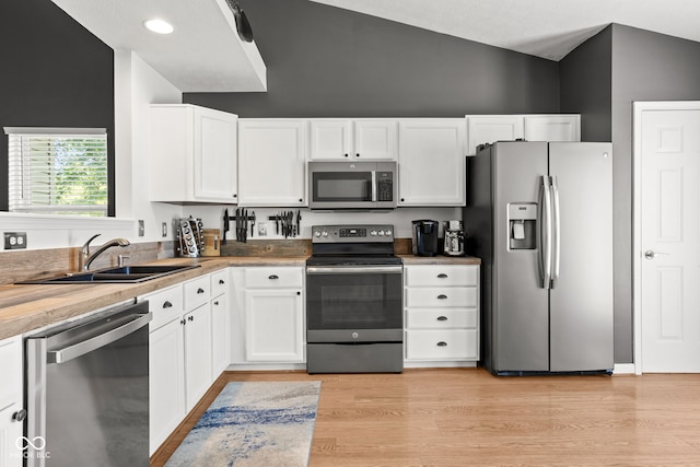 12384 Barnstone Ct, Fishers, IN 46037 - kitchen with stainless steel appliances, lofted ceiling, white cabinets, light wood finished floors, and light countertops