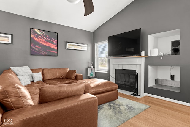 12384 Barnstone Ct, Fishers, IN 46037 - living area featuring wood finished floors, ceiling fan, lofted ceiling, and a tiled fireplace