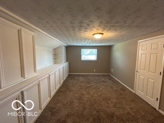 2732 Morning Star Dr, Indianapolis, IN 46229 - carpeted empty room featuring a textured ceiling and vaulted ceiling