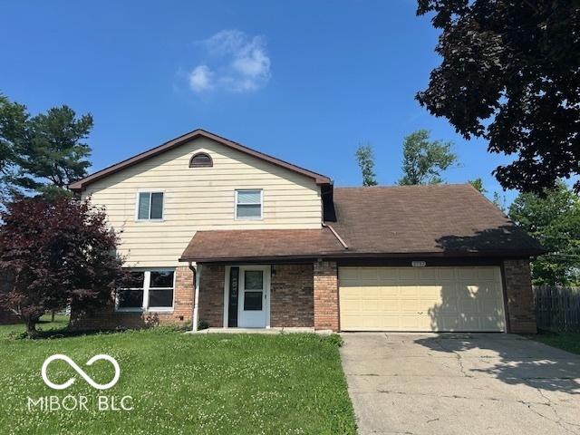 2732 Morning Star Dr, Indianapolis, IN 46229 - view of front of home with brick siding, concrete driveway, and an attached garage