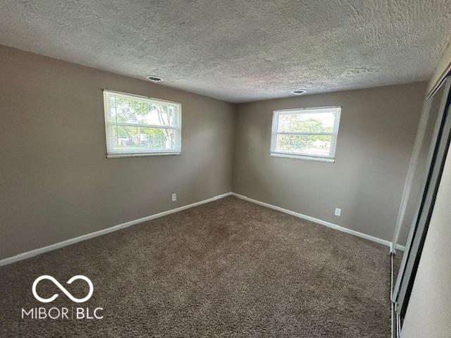 2732 Morning Star Dr, Indianapolis, IN 46229 - carpeted empty room featuring baseboards and a textured ceiling